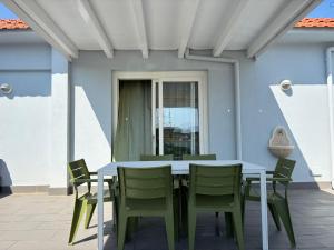 a dining table and chairs on a patio at La Conchiglia Case Vacanze in Balestrate