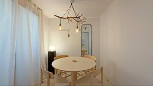a dining room with a white table and chairs at SOYO-SOOP Stay in Seoul +15 photos