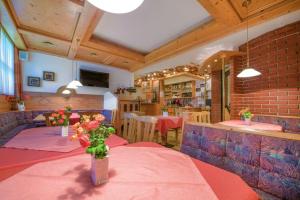 a dining room with a table with flowers on it at Margarete Gwehenberger in Kleinarl +41 photos