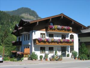 a white building with flowers on the balconies at Margarete Gwehenberger in Kleinarl