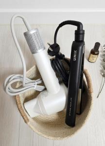 a basket with a hair dryer and a blow dryer and a hairbrush at SOYO-SOOP Stay in Seoul