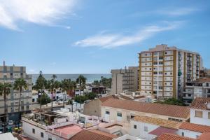 a view of a city with buildings and the ocean at Sol y breeze in Torre del Mar