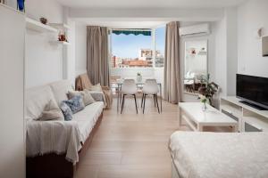 a living room with a couch and a table at Sol y breeze in Torre del Mar