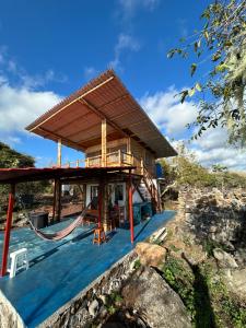 a house under construction with a hammock on the deck at Highland Bamboo Cabin, San Cristóbal Galápagos in San Cristóbal