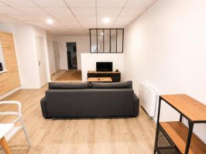 a living room with a couch and a table at Studio des quais in Saint-Aignan