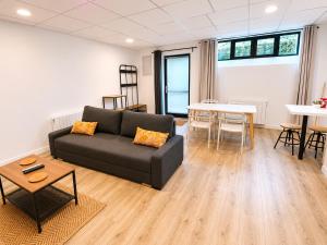 a living room with a couch and a table at Studio des quais in Saint-Aignan