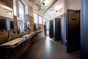 a bathroom with a row of sinks and mirrors at Das Boot Triberg in Triberg