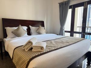 a bedroom with a bed with towels on it at Moringa Stays Formerly Deep International in Mandrem