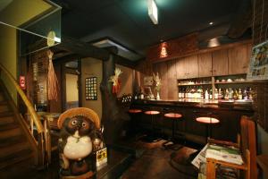 a bar with a teddy bear standing in a room at お宿玄河 in Minamioguni