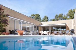 a swimming pool in front of a house at Viana Vista Villa in Viana do Castelo