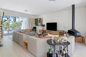a living room with a couch and a tv at Viana Vista Villa in Viana do Castelo