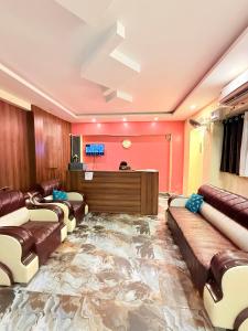 a living room with a large fake floor with leather furniture at Amba heritage house in Prayagraj