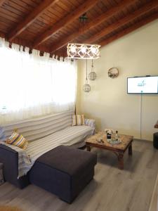 a living room with a couch and a table at komi's family house in Kómi