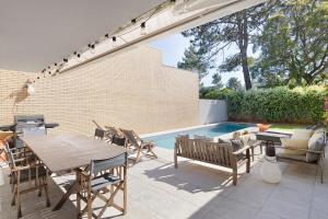 a patio with a table and chairs and a pool at Viana Vista Villa in Viana do Castelo