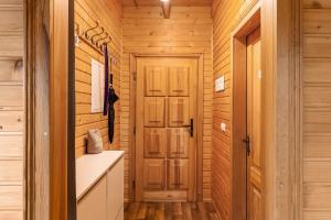 a bathroom with wooden walls and a wooden door at Ferienhaus Sonne in Hohnstein +18 photos