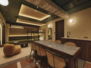 a waiting room with a table and chairs at illi Harb Shibuya-Ebisu in Tokyo +51 photos