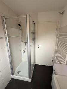 a shower with a glass door in a bathroom at Ferienhaus SPO 54 grad in Böhl +41 photos