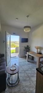 a living room with a couch and a table at Alma-Libre house 2 in Kefalos