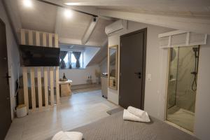 a living room with a sliding door and a television at Cosmopolitan Suites in Parga +89 photos