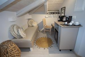 a small living room with a couch and a table at Cosmopolitan Suites in Parga