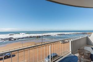 a balcony with a view of the beach and the ocean at Cozumel 216 in Umdloti