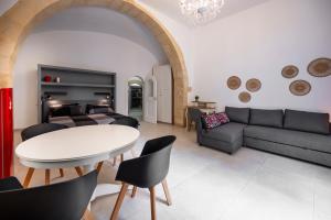 a living room with a couch and a table at Kore in Noto