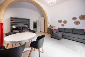 a living room with a couch and a table at Kore in Noto