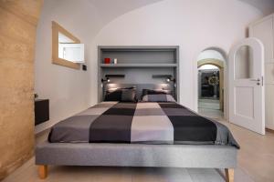 a bedroom with a large bed in a room at Kore in Noto +7 photos