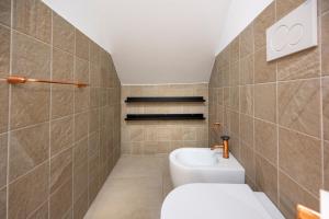 a bathroom with a toilet and a sink at Kore in Noto