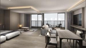 a hotel room with a bed and a dining room at Village Atami in Atami