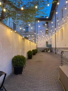 a courtyard with lights and potted plants in a building at Hotel Dolynskiy in Lviv