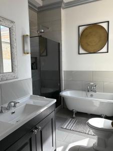 a bathroom with a tub and a sink and a toilet at Sea view Villa Holiday and Corporate Let Accommodation in Prestwick +27 photos
