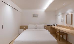 a small room with a bed and a desk at Chuncheon Bom Stay in Chuncheon