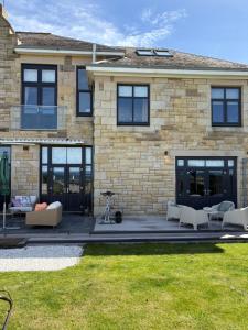 a patio in front of a brick building at Sea view Villa Holiday and Corporate Let Accommodation in Prestwick