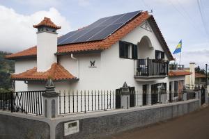a house with solar panels on the roof at Villa Borboleta in Santana