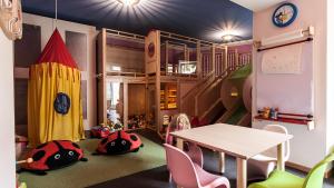 a childs play room with a table and chairs at Plavna Serviced Apartments in Scuol