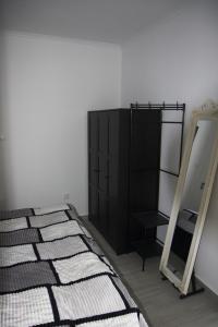 a bedroom with a mirror and a black cabinet at Villa Borboleta in Santana +45 photos