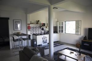 a living room with a couch and a table at Villa Borboleta in Santana