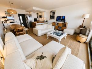 a living room with two white couches and a table at Le Touquet Beach, Front de Mer & Garage in Le Touquet-Paris-Plage