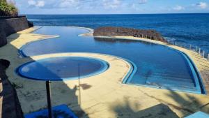 a swimming pool in the middle of the ocean at Villa Borboleta in Santana