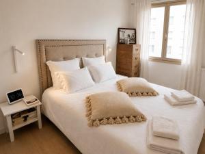 a bedroom with a large white bed with white pillows at Le Touquet Beach, Front de Mer & Garage in Le Touquet-Paris-Plage