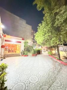 a building with a courtyard with a tree in front of it at Amba heritage house in Prayagraj +17 photos