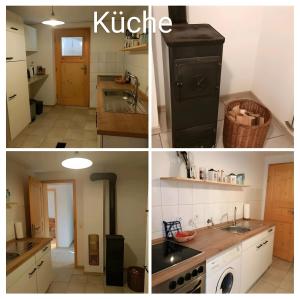 a kitchen with a black stove and a sink at Ferienwohnung Landblick Lalling in Lalling