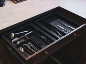 a drawer in a cabinet filled with cooking utensils at illi Harb Shibuya-Ebisu in Tokyo