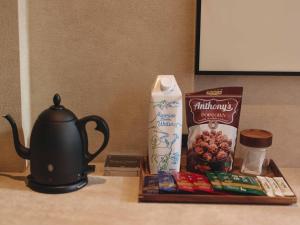 a table with a tea kettle and a tray of food at illi Harb Shibuya-Ebisu in Tokyo