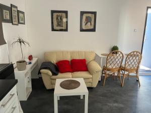 a living room with a couch and two chairs at Apartmán Vodolka in Odolena Voda