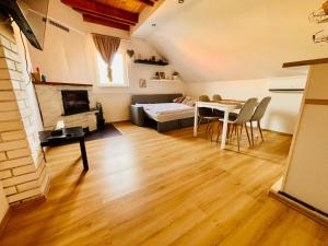 a living room with a couch and a table at Apartmán Pura Vida in Zaječí