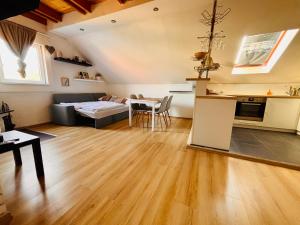 a living room with a couch and a table at Apartmán Pura Vida in Zaječí