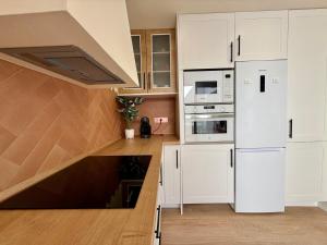 a kitchen with white cabinets and a white refrigerator at Casa Pilara Alojamiento rural in Callosa de Segura +14 photos