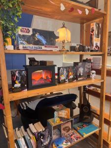a book shelf filled with lots of books at Terlyn Hostel & Cafe in Amphoe Phra Khanong